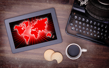 Image showing World map on a tablet