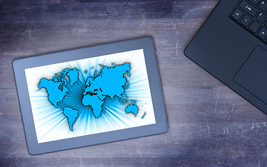 Image showing World map on a tablet