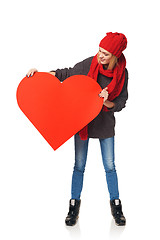 Image showing Full length girl holding up a red cardboard heart