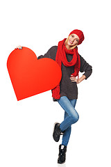 Image showing Full length girl holding up a red cardboard heart