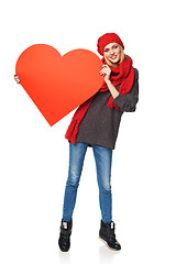 Image showing Full length girl holding up a red cardboard heart