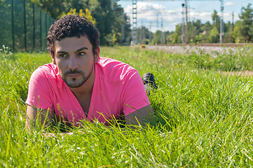 Image showing Handsome man in pink near railway 