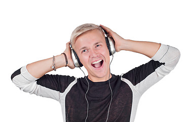 Image showing Young handsome man singing with headphones 