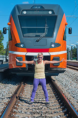 Image showing Young trendy guy in front of train