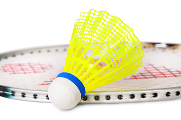 Image showing One shuttlecock lying near the badminton racket