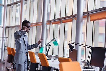 Image showing African American businessman talk by phone