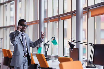 Image showing African American businessman talk by phone