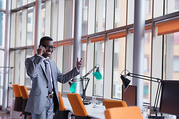 Image showing African American businessman talk by phone
