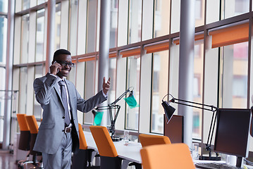 Image showing African American businessman talk by phone