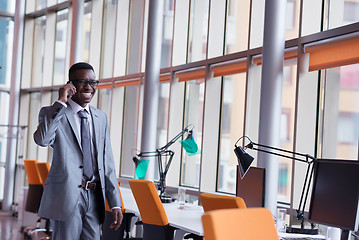 Image showing African American businessman talk by phone