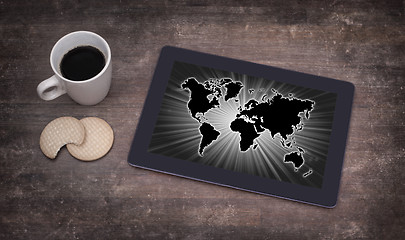 Image showing World map on a tablet