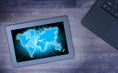 Image showing World map on a tablet