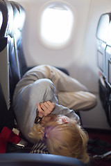 Image showing Young woman sleeping on airplane