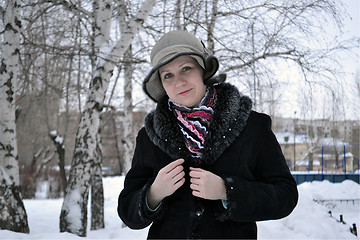 Image showing The woman in a hat and a sheepskin coat costs in park in the win