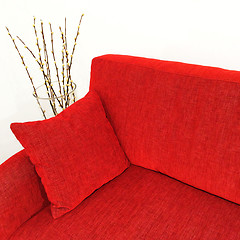 Image showing Red velvet sofa and willow branches in a vase