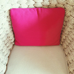 Image showing Pink cushion decorating a beige armchair