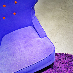 Image showing Fancy blue armchair on purple carpet