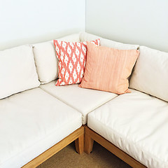 Image showing White corner sofa with pink cushions