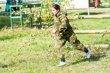 Image showing Teenage girl jumped through obstacle