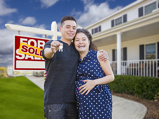 Image showing Hispanic Couple with Keys In Front of Home and Sign