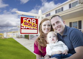 Image showing Young Military Family in Front of Sold Sign and House