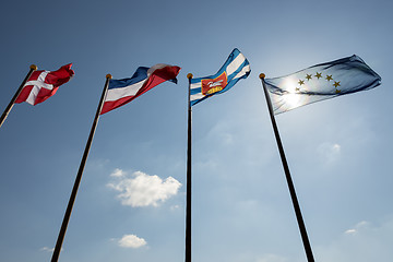 Image showing Blue sky with four flags