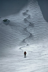 Image showing Male skier riding down the hill