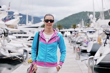 Image showing relaxed young woman walking in marina