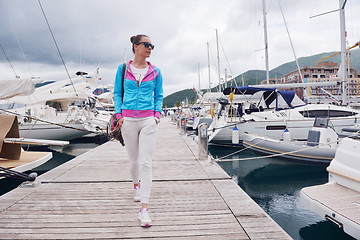 Image showing relaxed young woman walking in marina