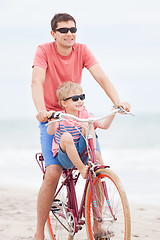 Image showing family biking at the beach