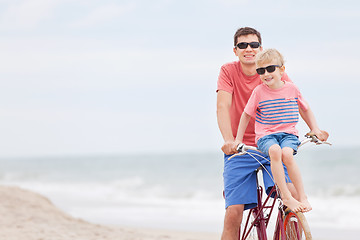 Image showing family biking at the beach