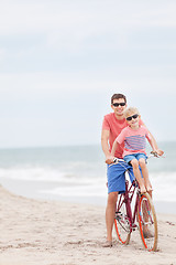 Image showing family biking at the beach