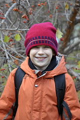Image showing portrait of the joyful teenage boy in the autumn wood.