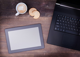 Image showing Tablet touch computer gadget on wooden table