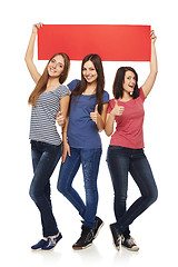 Image showing Three girl friends with red banner