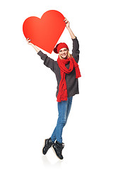 Image showing Full length girl holding up a red cardboard heart