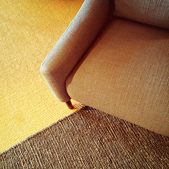 Image showing Textile armchair and knitted carpet in warm colors