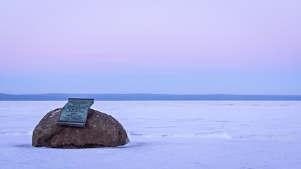 Image showing Memorial plaque on boulder on lake shore in winter