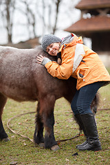 Image showing Little girl with pony