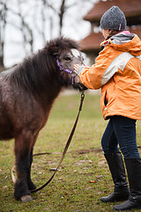 Image showing Little girl with pony