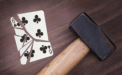 Image showing Hammer with a broken card, six of clubs