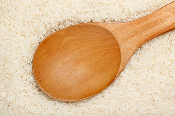 Image showing Wooden spoon on Thai fragrant jasmine rice