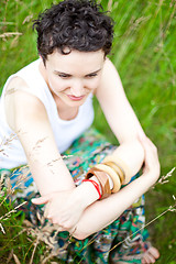 Image showing cute girl resting on fresh spring grass 