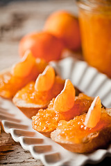 Image showing pieces of baguette with orange marmalade 