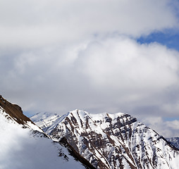 Image showing Winter snowy mountains and sky with clouds