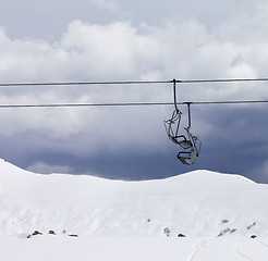 Image showing Chair lifts and off piste slope at gray day