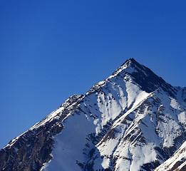 Image showing Snowy rocks in sun evening