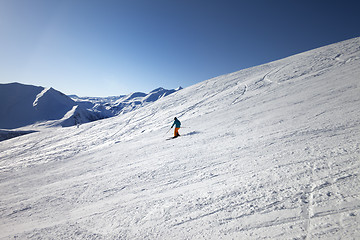 Image showing Skier on slope in sun day