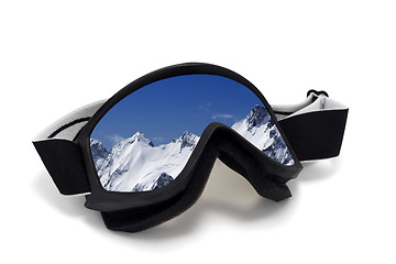 Image showing Ski goggles with reflection of snowy mountains in nice day