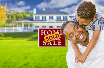 Image showing Father and Son In Front of Sold Sign and House